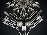 a lot of spoons and forks arranged in the shape of a heart