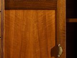 a close up of a wooden cabinet with a door handle