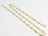 a close up of a gold chain with a coin on it