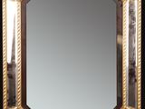 une image représentant un miroir au cadre doré sur fond noir