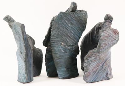 three pieces of art that are sitting on a white surface