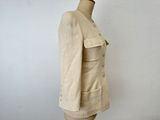 beige jacket on a mannequin dummy against a white wall