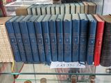 a lot of books on display in a glass case