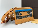 louis vuitton wallet case in tan leather with a blue label on the front