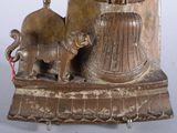 a statue of a woman and a cat on a table