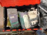 many bags of clothing in a red box