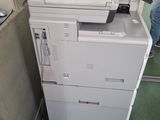 a printer that is sitting on top of a cabinet
