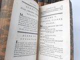 an open book that is sitting on top of a wooden table