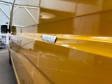 a yellow van with a sticker on the side of it