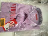 a purple shirt that is wrapped in plastic on a table
