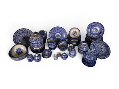 a group of blue and white plates and bowls on a white surface