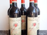 three bottles of red wine are lined up on a table