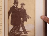 a person holding a book with a picture of a man and a woman on it