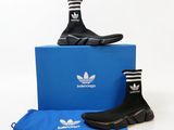 adidas shoes and a blue bag are sitting on a white surface