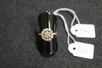 a black ring with a gold and white flower on it