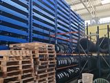 a large warehouse filled with lots of pallets and chairs