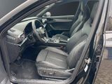 the interior of a car with the door open and the driver ' s seat down
