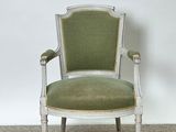 an image of a chair with a green upholstered seat in a room