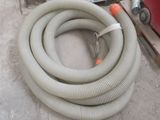 a hose that is laying on the ground next to a machine