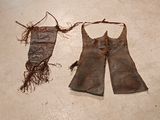 a pair of leather gloves and a bag on the floor