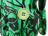 an image of a green and black dress with a button on it
