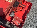 a red tool box with tools in it on the ground