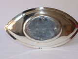 a silver plate with a silver eye on it
