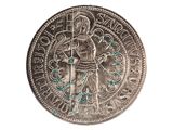 an old silver coin with a man holding a sword on top of it