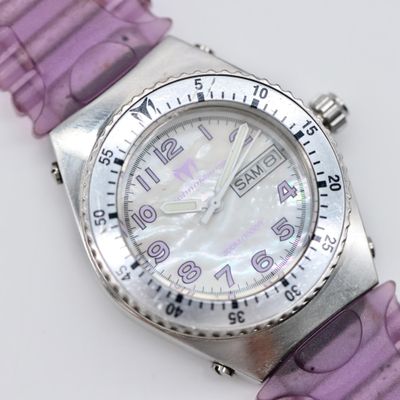 a close up of a watch on a white surface