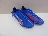 a pair of blue and red soccer shoes on a white surface