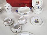 a table with a red box and a set of dishes and cups