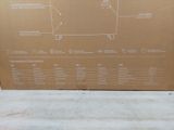 a cardboard box with a diagram on it sitting on the ground