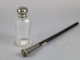 a small glass bottle with a metal cap next to a small glass bottle with a metal cap