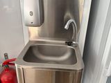 a sink and a fire extinguisher next to a fire extinguisher