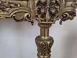 an antique console table with a marble top and gold accents
