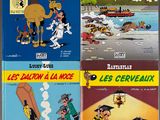 four books of french comics are on display in front of the eiffel tower