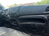 the interior of a truck with a black leather seat and dashboard
