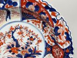 a blue and red plate with a bird on it