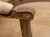 a close up of the arm of a chair with a button on it