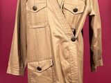 an image of a tan trench coat on a mannequin stand