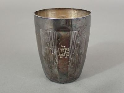 a silver cup with a design on it on a table