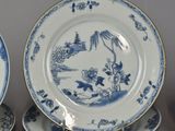 three blue and white plates with designs on them sitting on a table