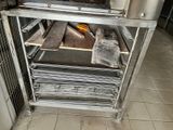 an image of a kitchen with a stove and a rack