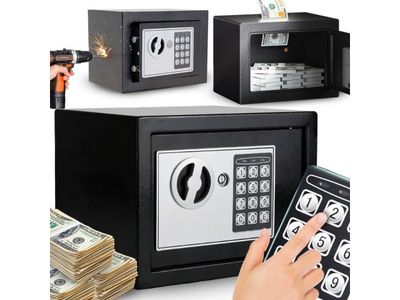 a hand that is holding a remote control in front of a safe box