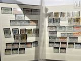 a display of stamps on display in a glass case