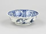 blue and white porcelain bowl with a design of a tiger and flowers