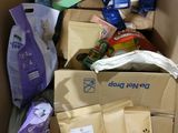 a cardboard box filled with dog food and other items