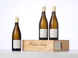 three bottles of wine in a wooden box with a white background