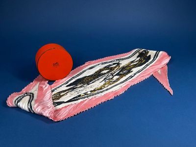 a red frisbee sitting on top of a pink bag