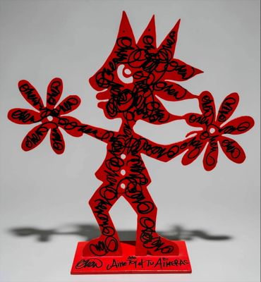 red and black paper cut sculpture of a man holding flowers